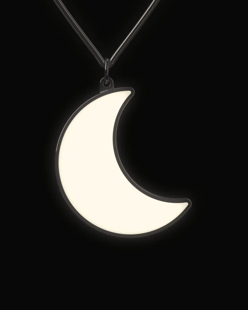 The Moon at night on its chain and jump ring, the stone face lit evenly in warm white.