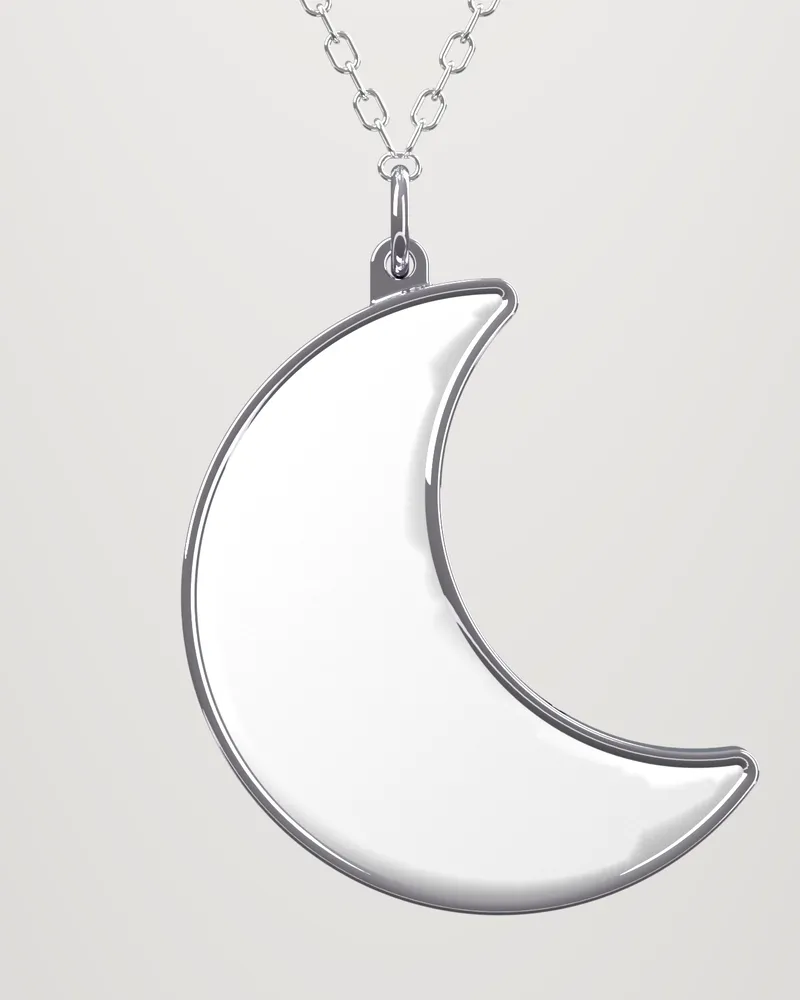 The Moon hanging from its jump ring on a fine chain: a white stone face in a mirror-polished steel rim.