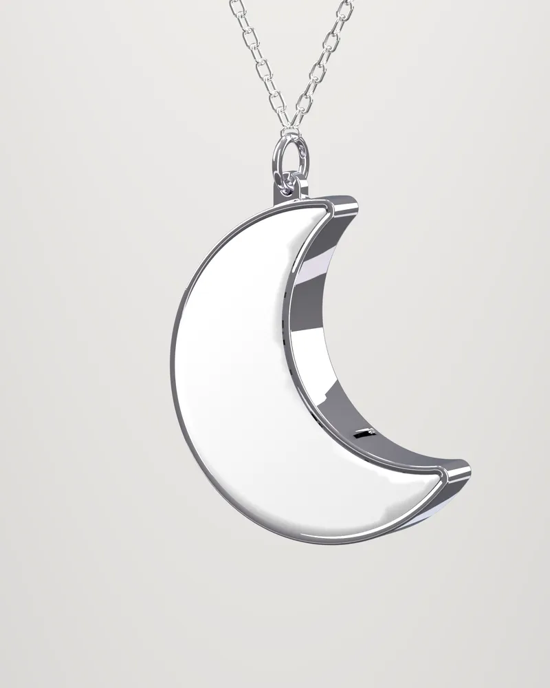 The Moon at an angle: the polished steel side, the stone face and the jump ring at the upper horn.