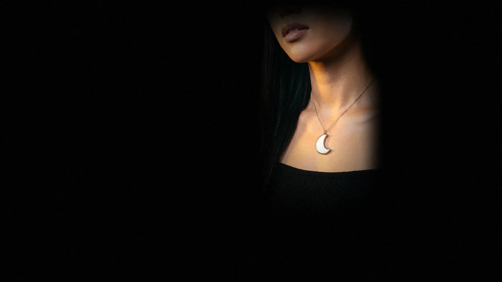Luna glowing at a woman's collarbone